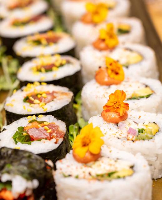 cut-up-sushi-rolls-trimed-with-flowers-and-radish-2025-10-16-09-18-07-utc